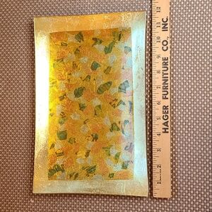 Vintage glass tray, pressed foil design in gold, yellow, orange, and green.